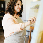 Rebecca Deneau painting in her Northern Michigan studio