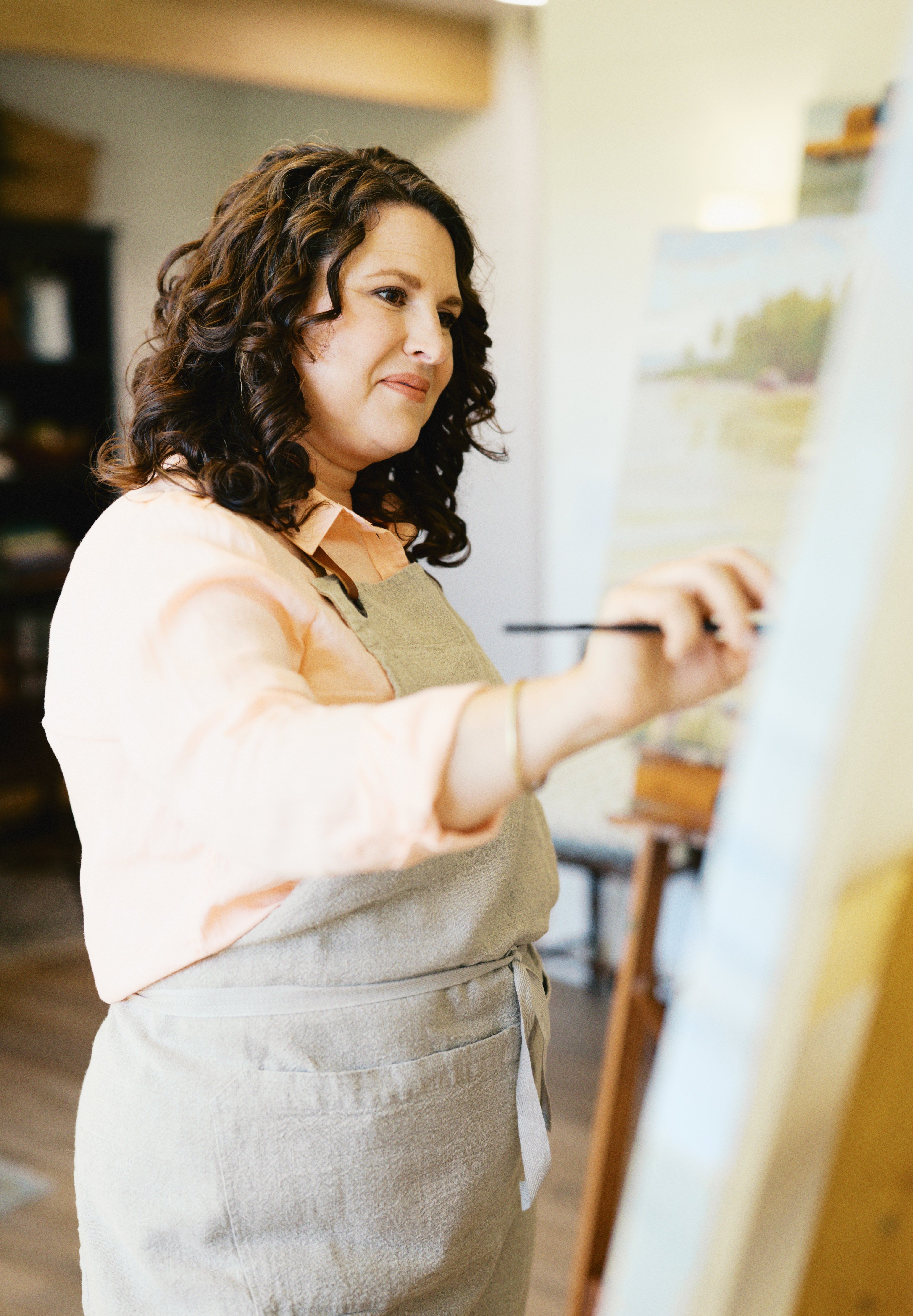 Rebecca Deneau painting in her Northern Michigan studio